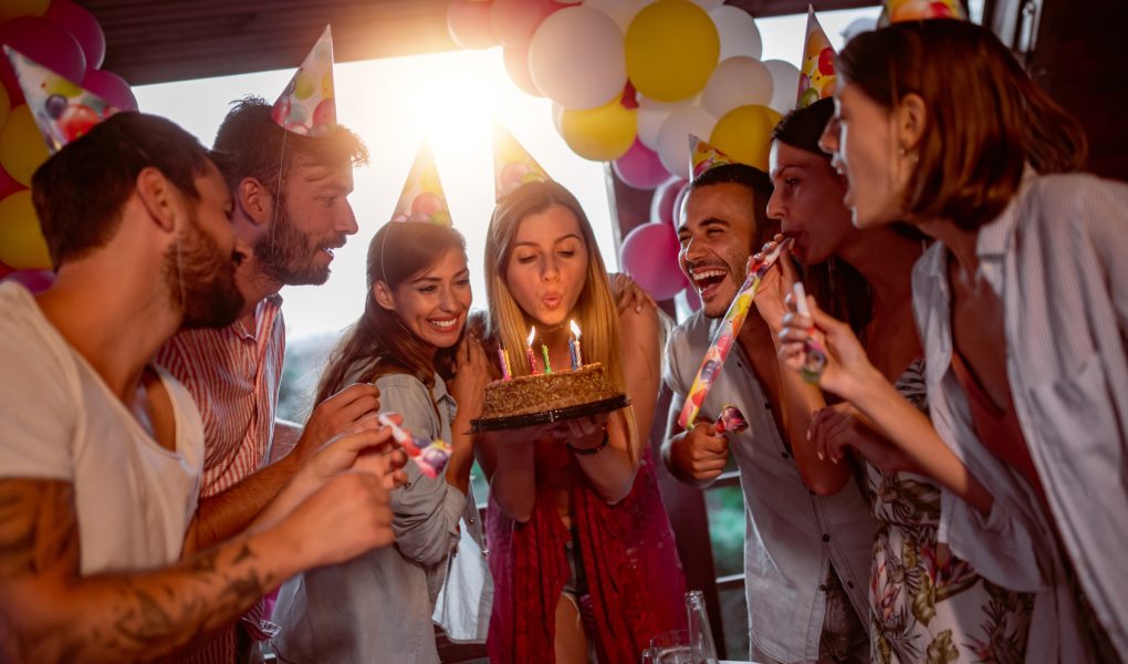 Groupe d'amis fêtant un anniversaire ensemble dans une salle
